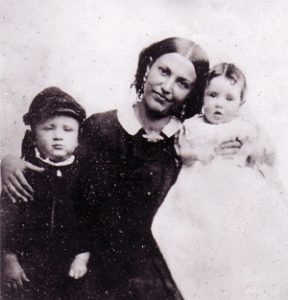 Woman with her arms around two children.