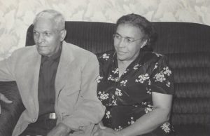 Black and white photo of Mignon with her husband, Thomas, sitting on a couch.