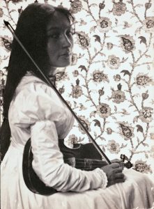 Native American woman holding a violin