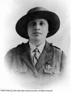 A woman wearing a hat and uniform with a medal.