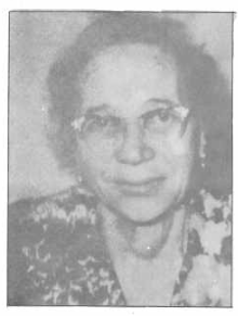 Woman looking at the camera wearing glasses.