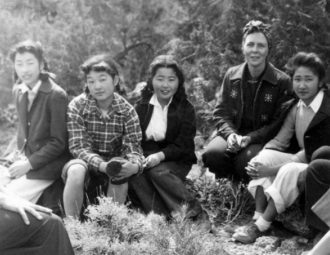 Teacher and students at Topaz, sitting in the brush.