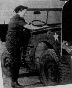 Woman wearing a bandana, repairing a truck.